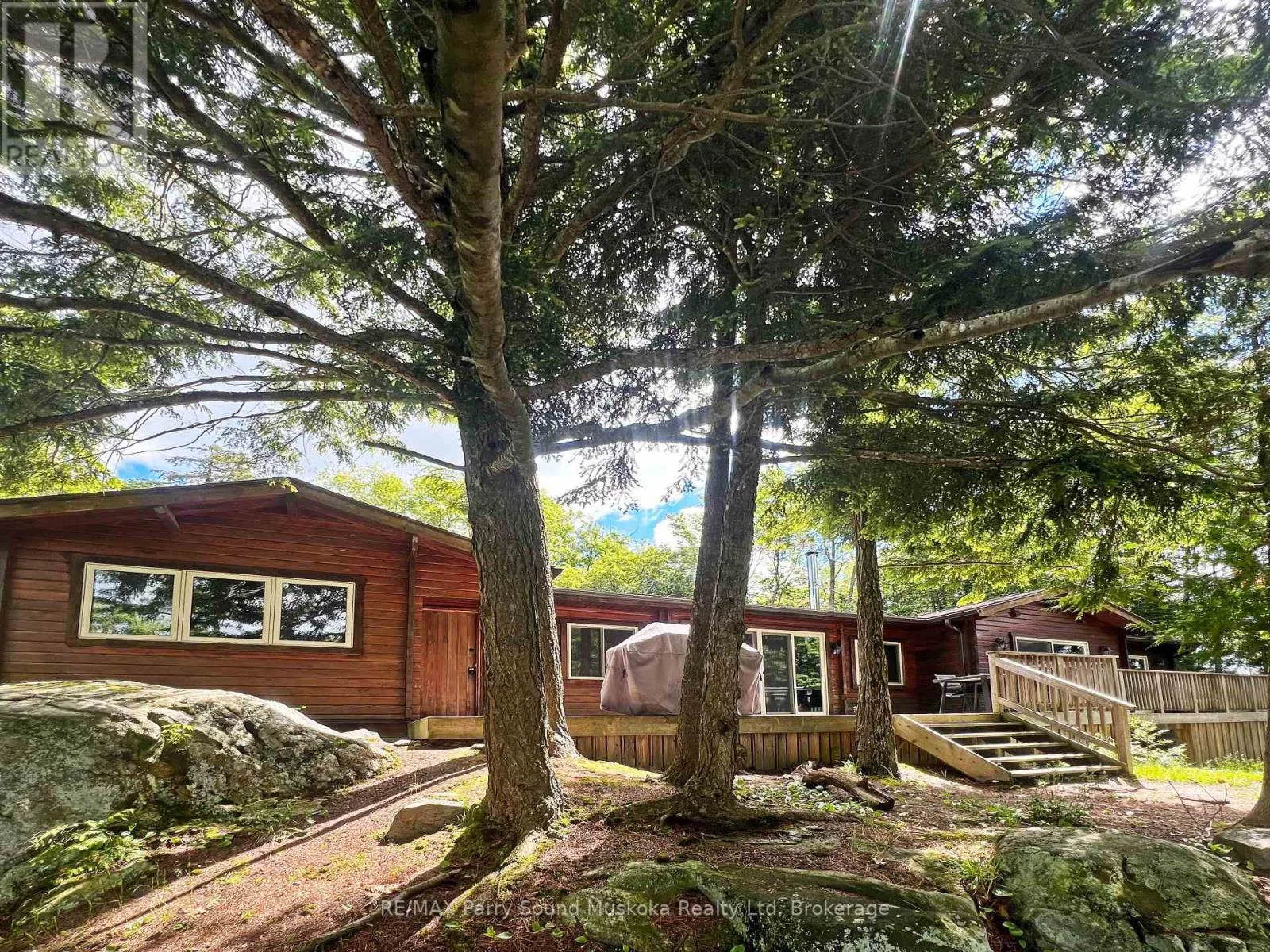 Exterior of the cedar cottage among mature trees